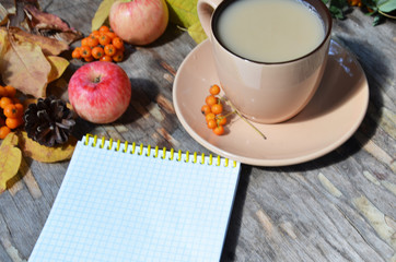 Workspace with golden leaves, notebook, coffee cup. Stylish office desk. Autumn or Winter concept. Flat lay, top view.