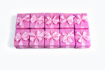 Rows of boxes with gifts decoration ribbon satin bow pink A top view of Flat lay