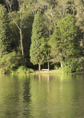 Lago Negro in the city of Gramado, Rio Grande do Sul, Brazil, with reflection of the sunset and trees around