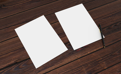 3D render of clean paper sheet. Template for your design. On wooden table.