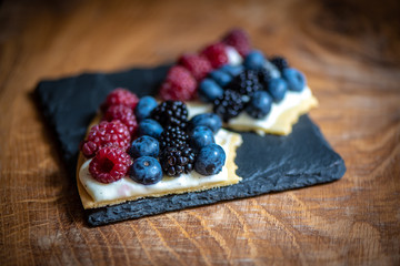 Delicious raspberry cake with fresh strawberries, raspberries, blueberry, currants