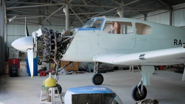Plane standing in aircraft hangar, plane engine, repairing the plane.