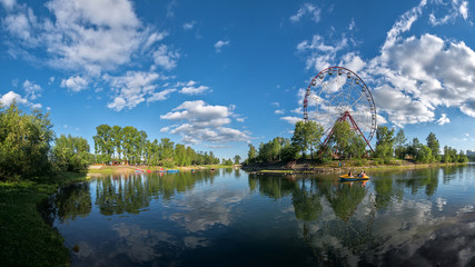 Fototapeta na wymiar The Ferris wheel on the bank of the Angara in Irkutsk