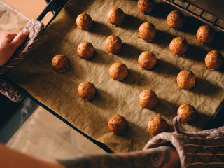 Hot prepared meat balls on baking sheet with paper