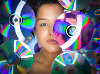 Portrait of beautiful woman among CDs