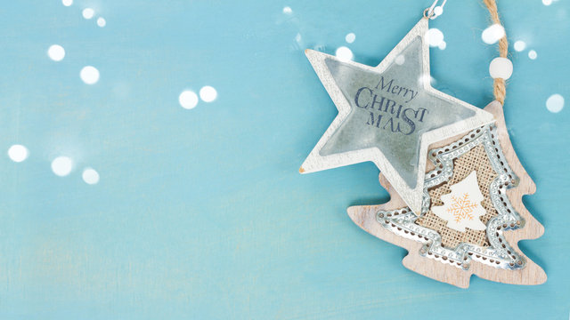 Blue and white christmas with star and christmas tree on blue wooden background banner with copy space