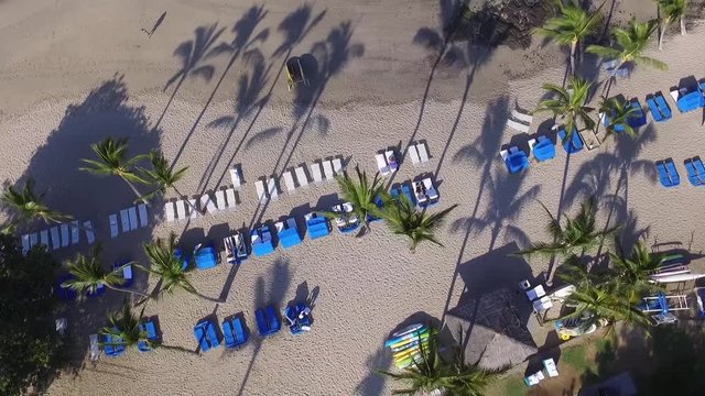 Tropical beach and pool surroundings from above in drone shot. Luxury hotel