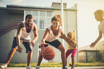 Fototapeta na wymiar Family playing basketball together.