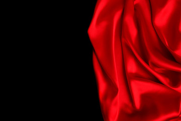 Red silk or satin luxury fabric texture can use as abstract background. Top view.