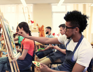 Fototapeta na wymiar Art students painting in workshop