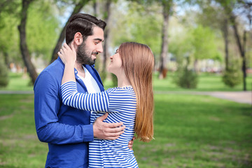 Happy young couple in park on spring day