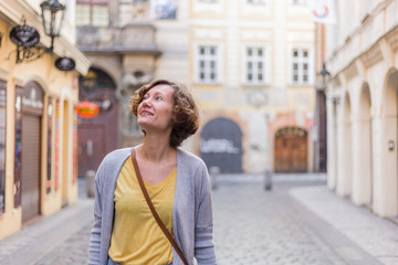 Obraz premium A tourist woman is walking around Prague on a sunny day.