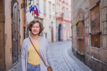 Fototapeta na wymiar A tourist woman is walking around Prague on a sunny day.