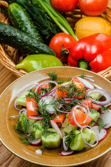 Fresh salad with tomatoes, onion and cucumbers.