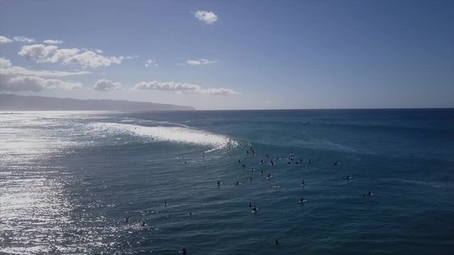 Big wave surfers out in the blue ocean. giant waves on beautiful sunny day