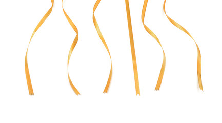 Curly golden ribbons on white background