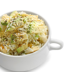 Pot with tasty boiled rice and avocado on white background