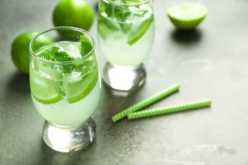 Glasses of fresh mojito on light table