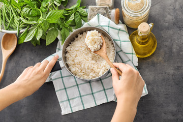 Woman with saucepan full of tasty rice