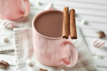 Cup of delicious cocoa on table, closeup