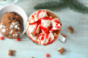 Cup of delicious cocoa with marshmallows on table