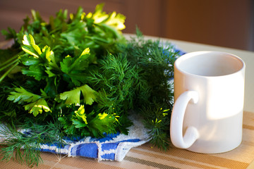 A bouquet of green parsley leaves with white mug.