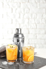 Glasses of tasty cold cocktail on slate plate