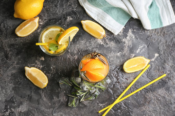 Glasses of tasty cold cocktails on dark table