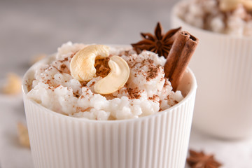 Cup with delicious rice pudding and nuts, closeup