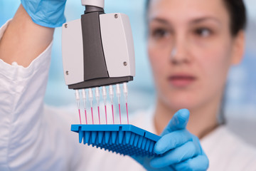 Young woman with genetic research in the laboratory research of cancer diseases