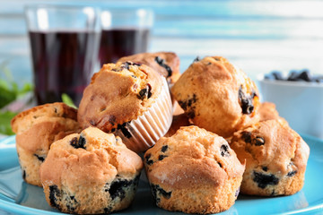 Tasty blueberry muffins on plate, closeup