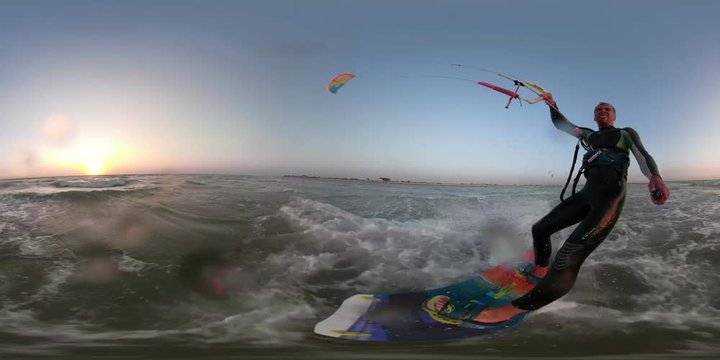 A happy man at sunset, holding a stick for selfie and kitesurfing on the sea