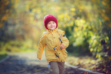 boy runnnig on the path in the park