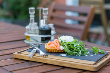 Egg poached with salmon and arugula.