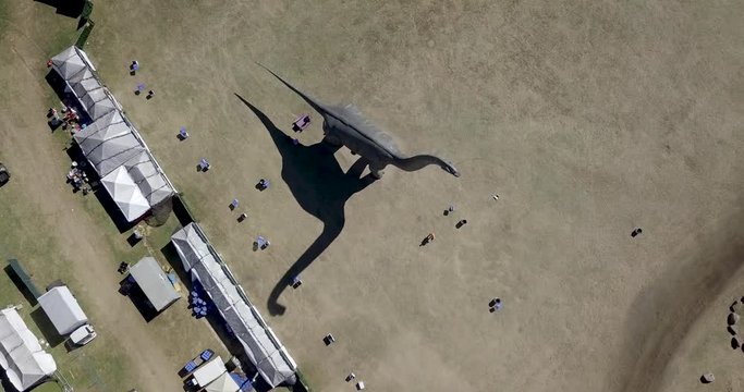 Birds Eye Drone Flight over Giant Dinosaur Statue
