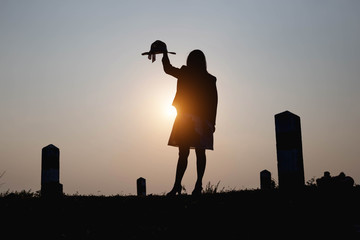 Happy woman on the sunset in nature in summer with open hands 