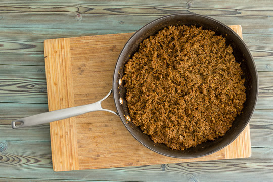 Kitchen skillet filled with cooked ground beef