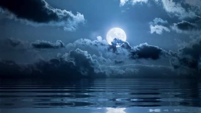 Full moon in clouds over ocean loopable animation