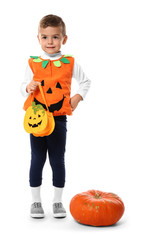 Cute little boy dressed as Jack-o-lantern for Halloween on white background