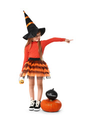 Cute little girl dressed as witch for Halloween on white background