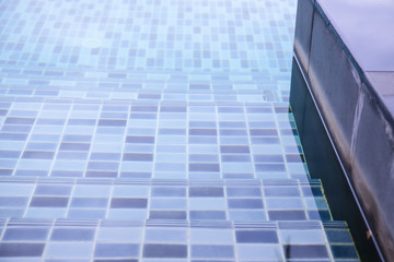 Close Up Swimming Pool.swimming pool bottom caustics ripple and flow with waves background.Swimming pool of luxury hotel.