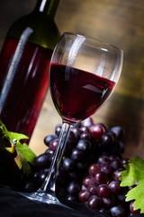 Wine Glass, Wine Bottle And Red Grape Clusters Close-up