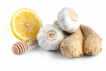 Isolated. Garlic, ginger,  lemon and honey spoons on a white background. Maintenance of immunity. Treatment of colds and flu. Products for immunity. Immunity concept.
