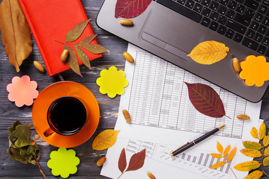 Office table with computer and autumn leaves. - Powered by Adobe
