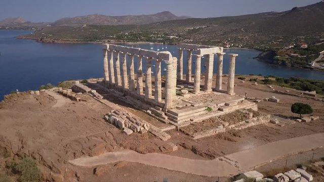 Greek Temple Of Poseidon In Morning Light. Aerial Drone.Blue Ocean Sailing Boats