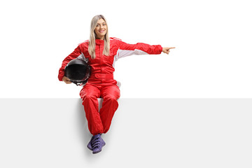 Fototapeta na wymiar Female racer seated on a panel pointing