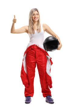 Female race driver holding her thumb up