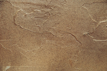 Repair, the design of the premises artistic multi-colored putty on the wall. Brown and vintage tones, background.