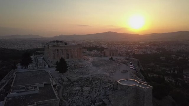 Temple and Greek flag beautifully at sunset.Athens Acropolis Parthenon evening