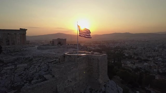 Temple and Greek flag beautifully at sunset.Athens Acropolis Parthenon evening